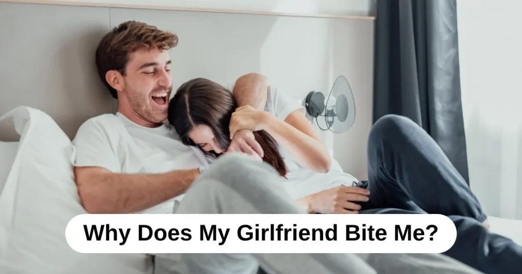 A couple laughing and play-wrestling on a bed